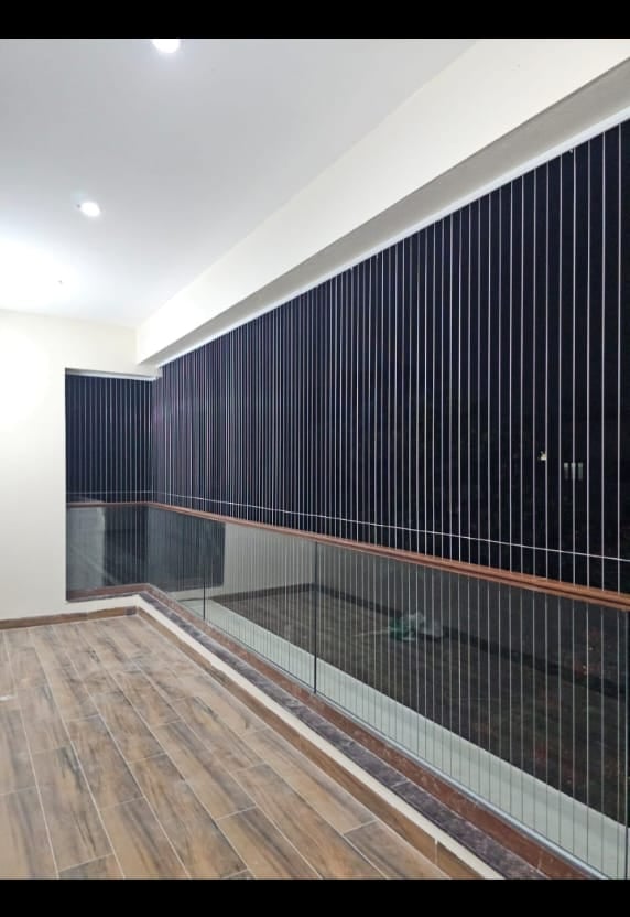 Wide shot of a modern apartment window fitted with invisible grills by Arjilli Enterprises