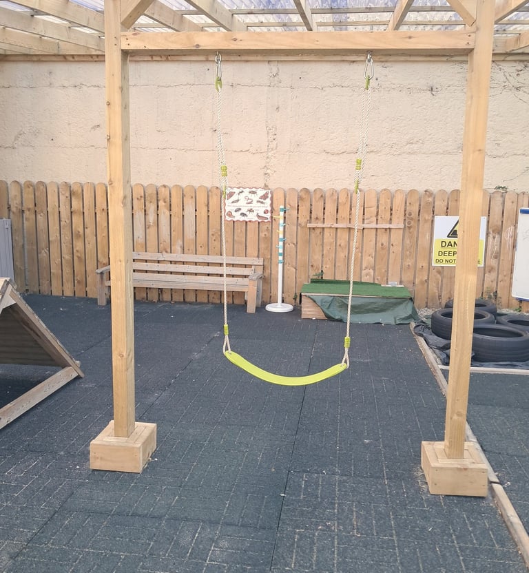 Swing inside Montessori playmates playground