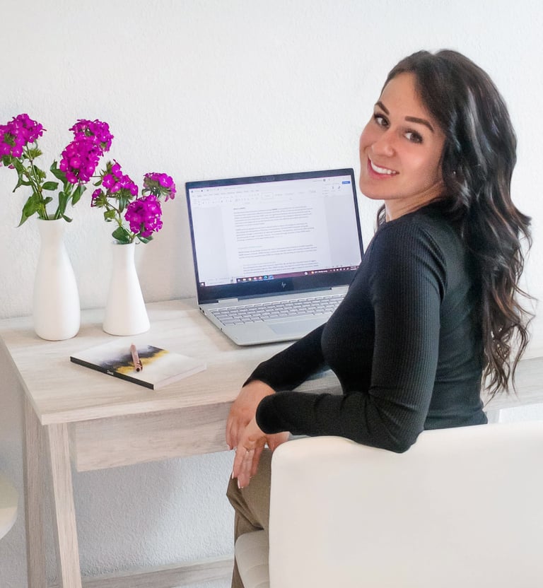 A professional writer sitting at their desk and smiling