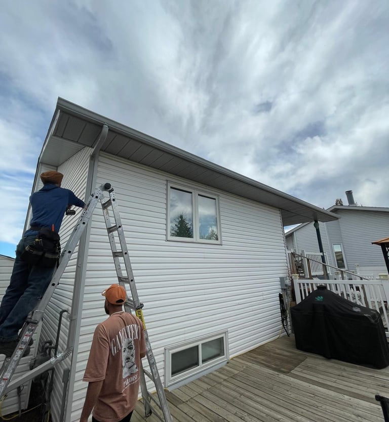Technician repairing damaged residential gutter.