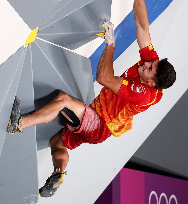 a man bouldering and putting a lot of effort