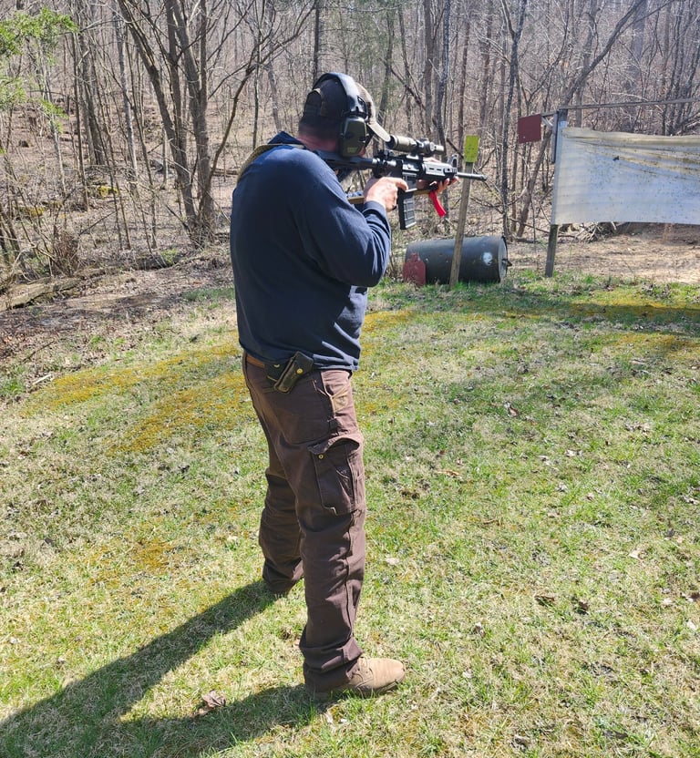 Man using self-defense firearm on range.