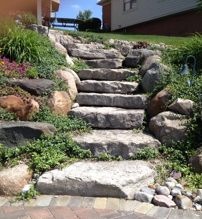 Leppek Landscape designed and installed natural ledge rock steps, retaining walls, perennials.