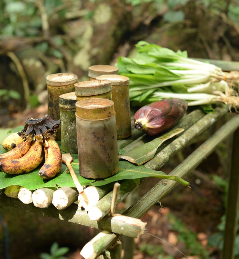 a table with bananas and other fruits and vegetables