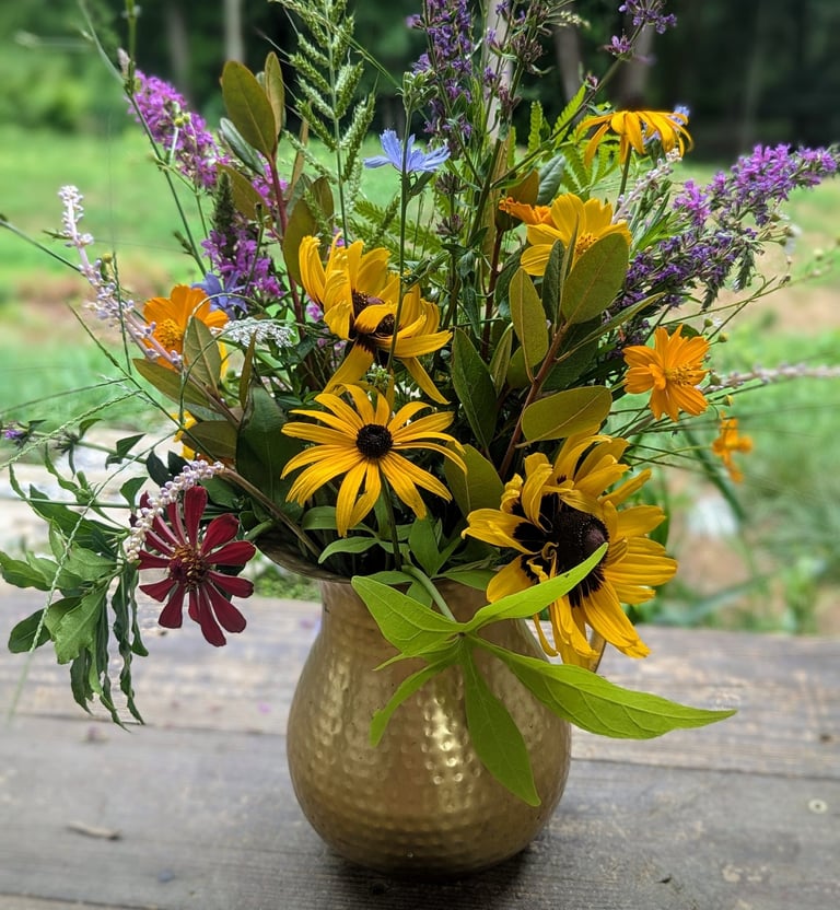 brass pitcher filled with seasonal blooms