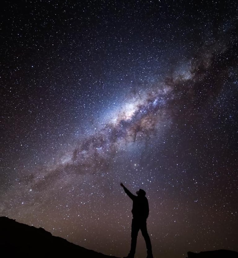 a person pointing at the stars in the sky