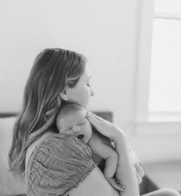 a woman holding a baby in her arms