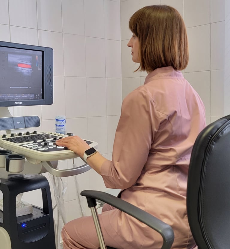 a woman in a pink shirt is sitting at a computer