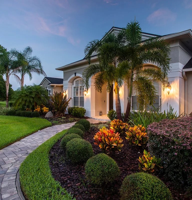 a house with a pathway leading to a driveway