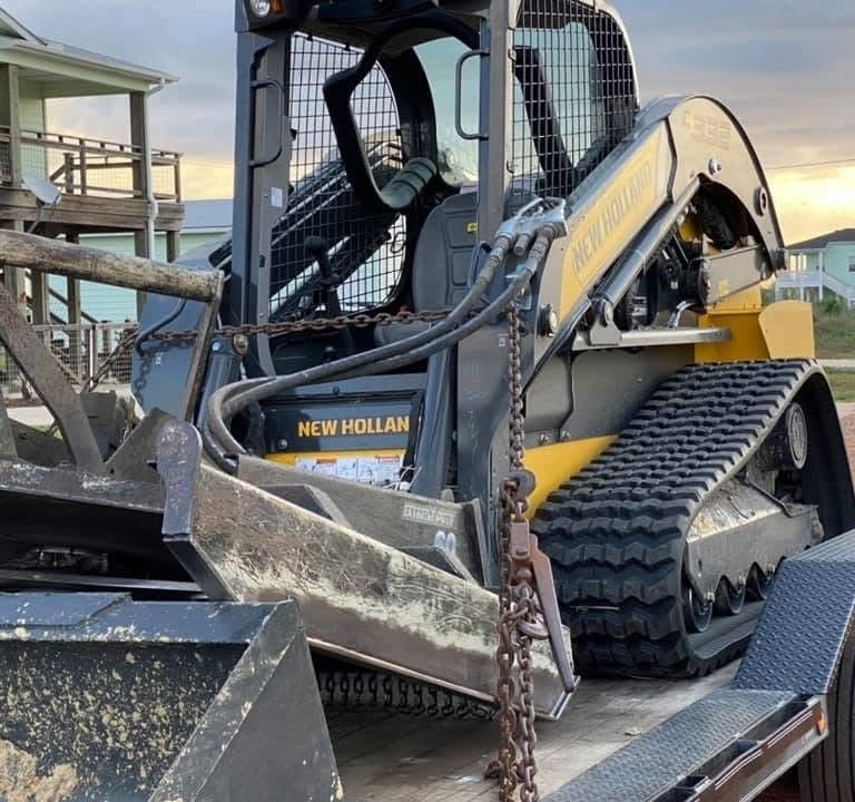 a construction tractor loaded onto a trailer