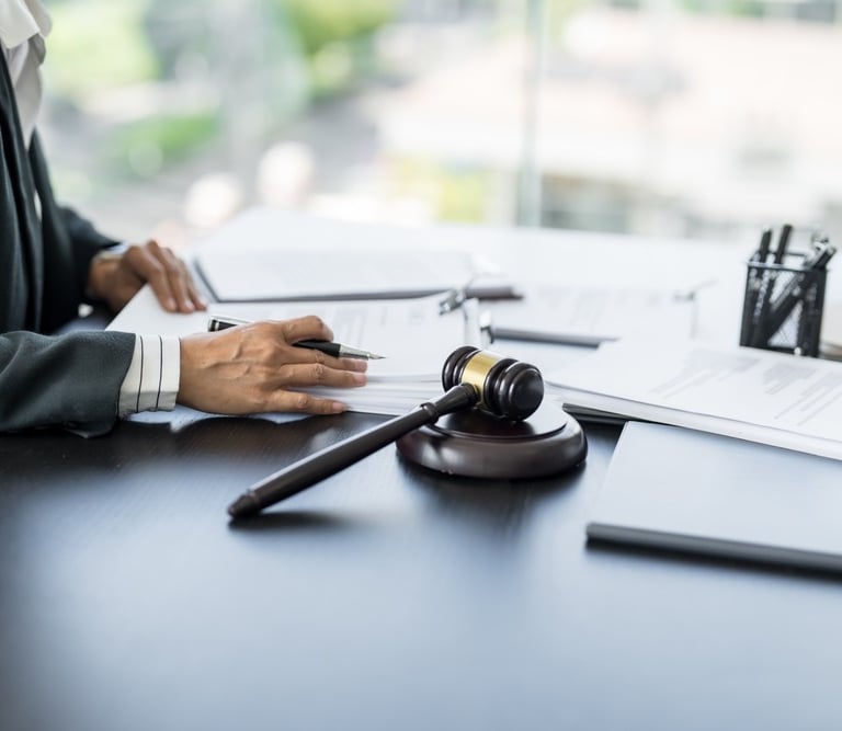 attorney reviewing paperwork at desk