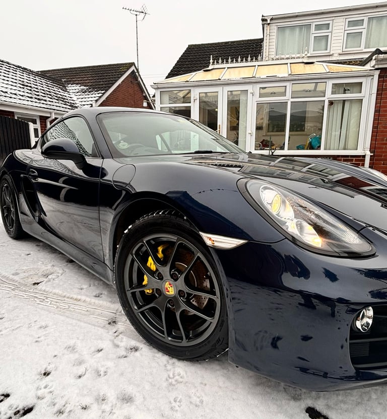 a pristine black Porsche sports car
