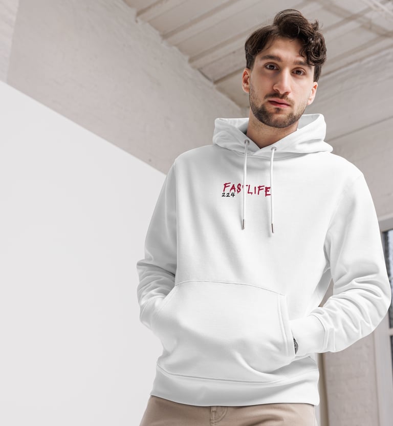 a man in a white hoodie and tan pants