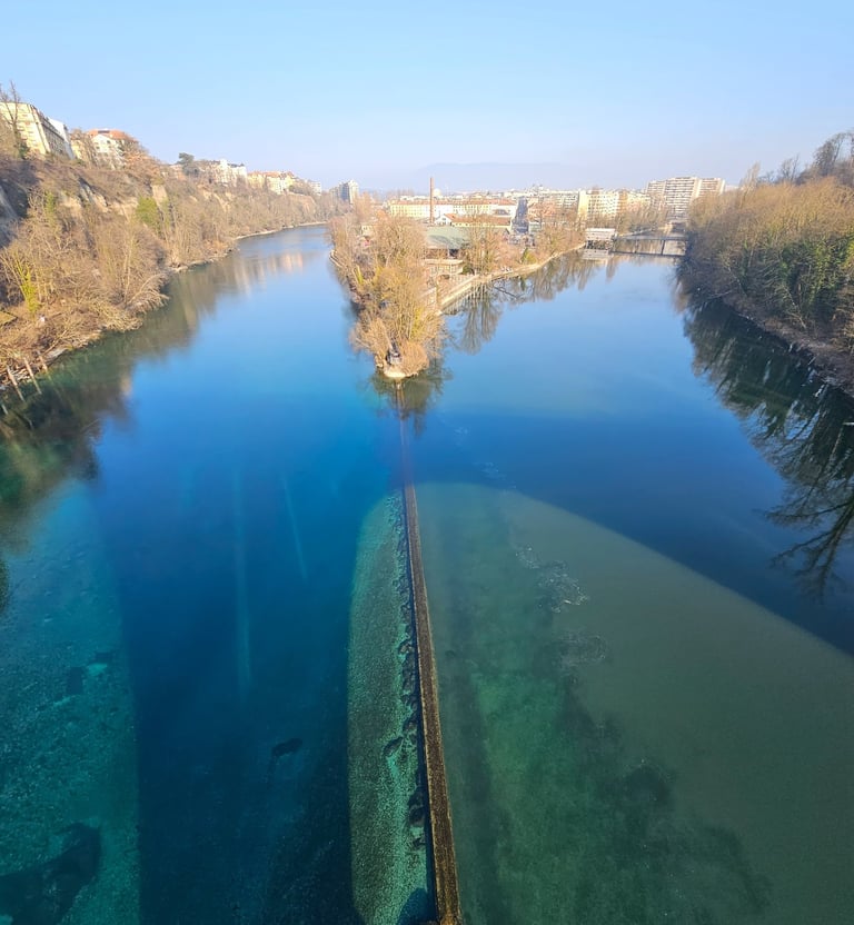 a river with a long line of water and a bridge