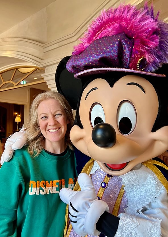 Leslie Hammer pictured with Mickey Mouse at Disneyland® Paris.