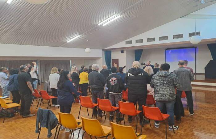 Congregation standing together in worship during a church service.