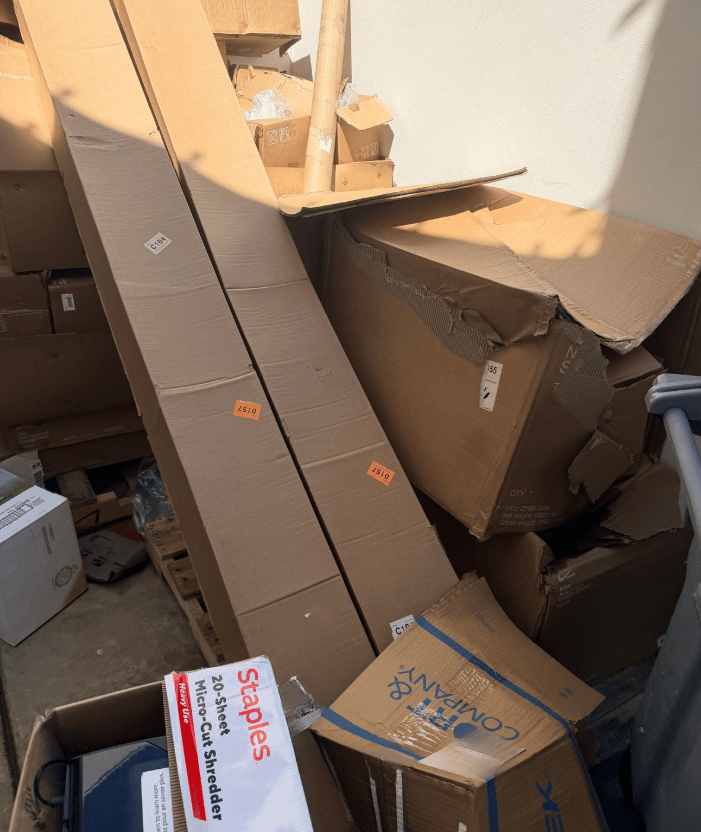 A big pile of card board boxes