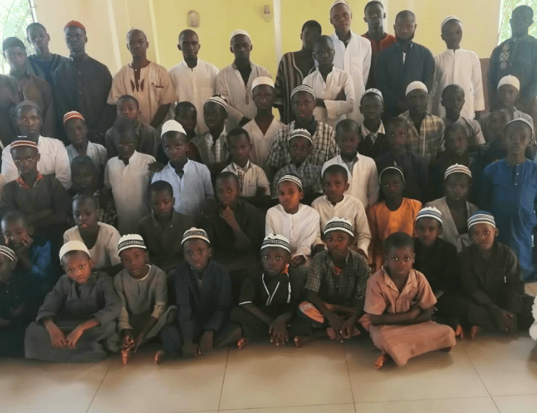a group of people standing around a group of children