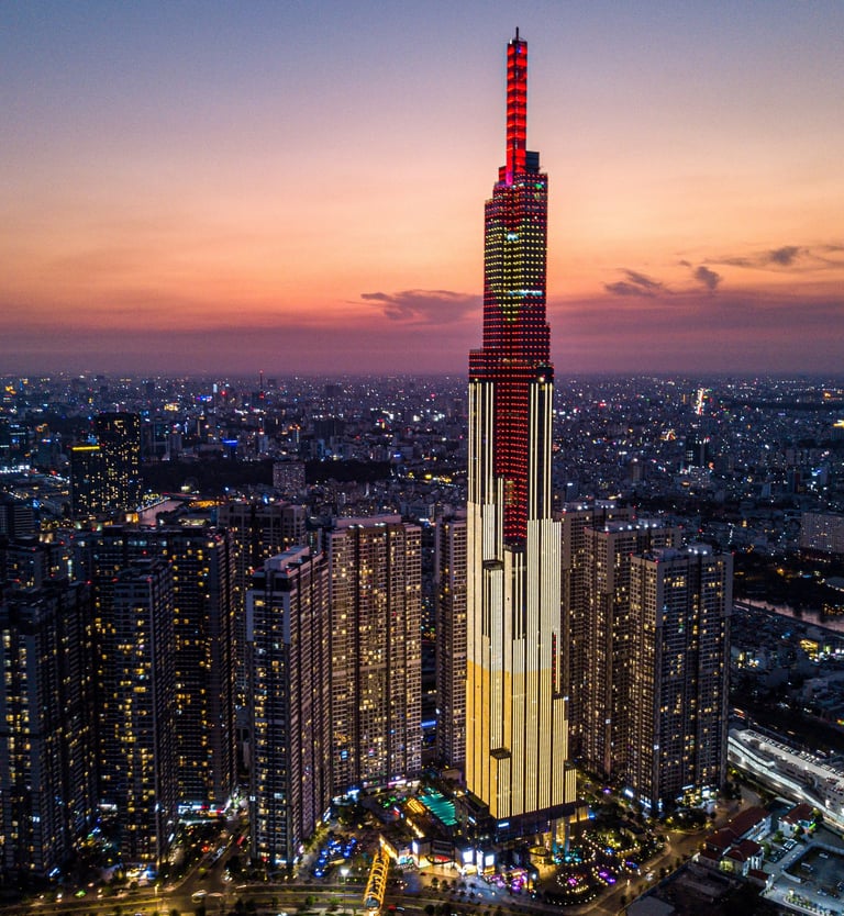Sunset over Saigon with Landmark 81, the tallest building in Vietnam, silhouetted against the sky.