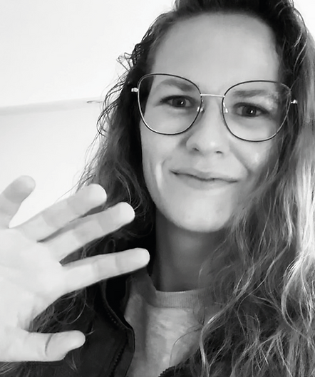 a woman with glasses and a jacket on