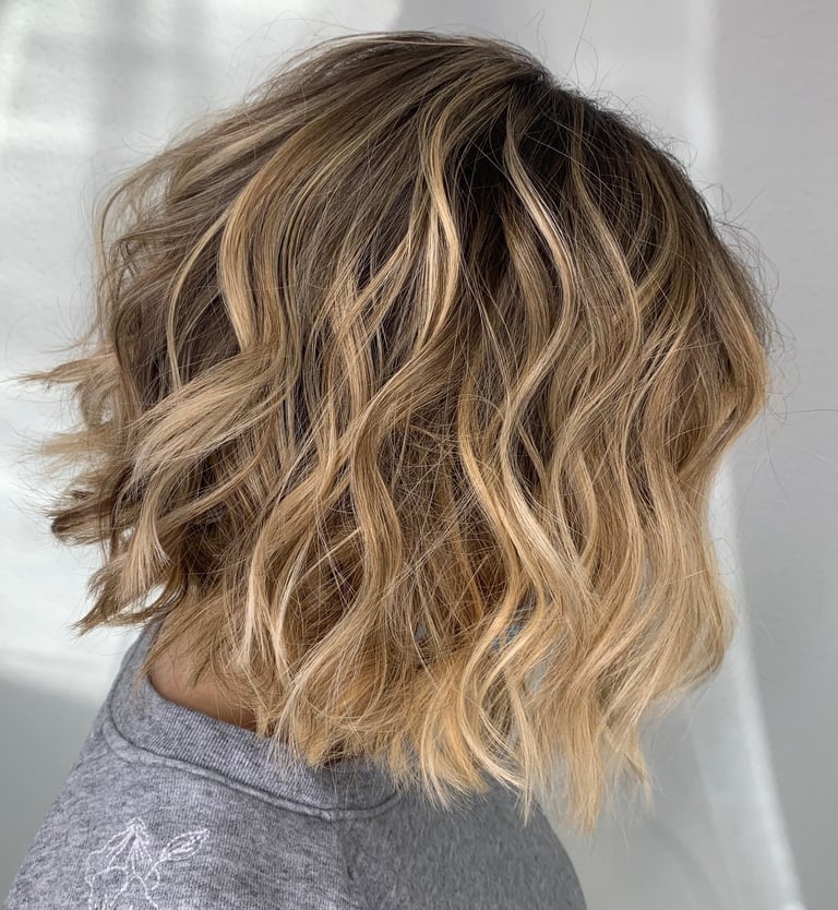 a woman with blonde hair and a grey shirt