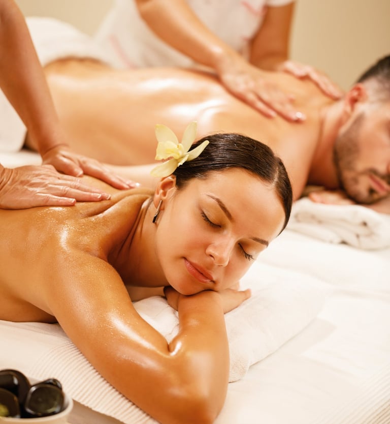 a man and woman getting a massage at a spa