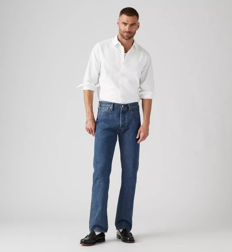 Levi’s 501 Original Fit Jeans styled with a white button-up shirt and black leather shoes.