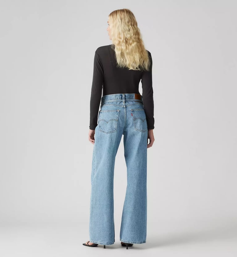 Back view of Levi’s XL Straight Jeans in light wash denim, styled with black top and heels.