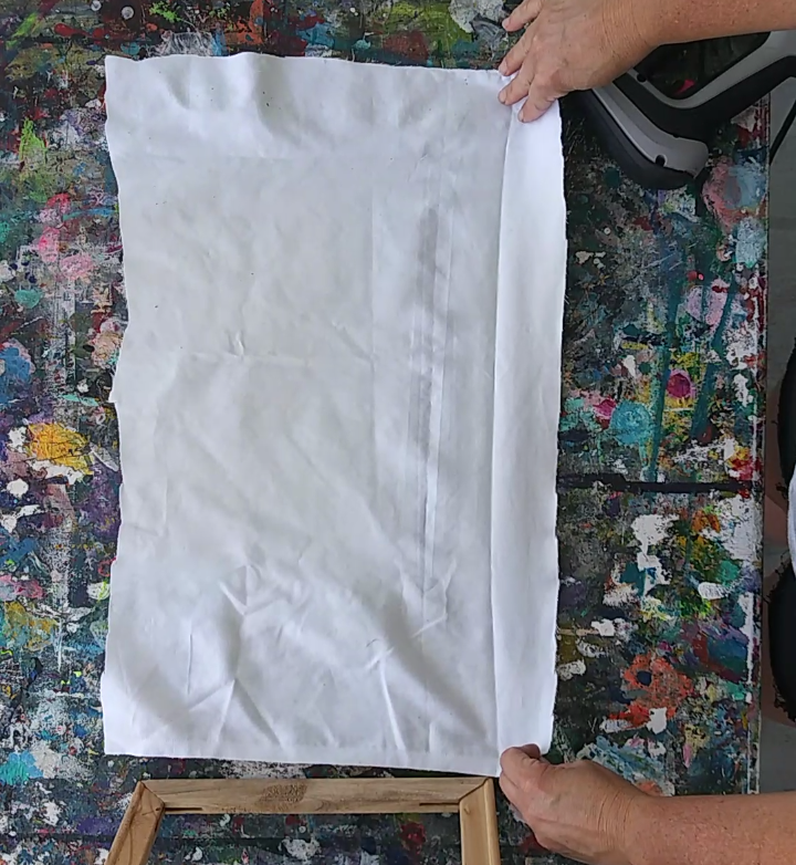 a person holding a piece of white fabric