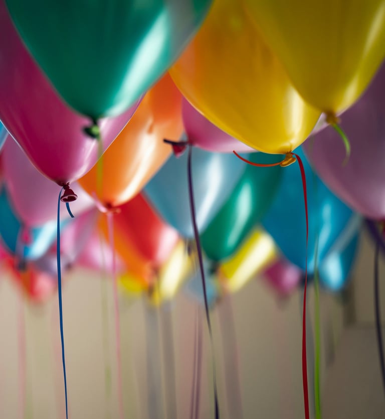 a bunch of colorful balloons floating in the air