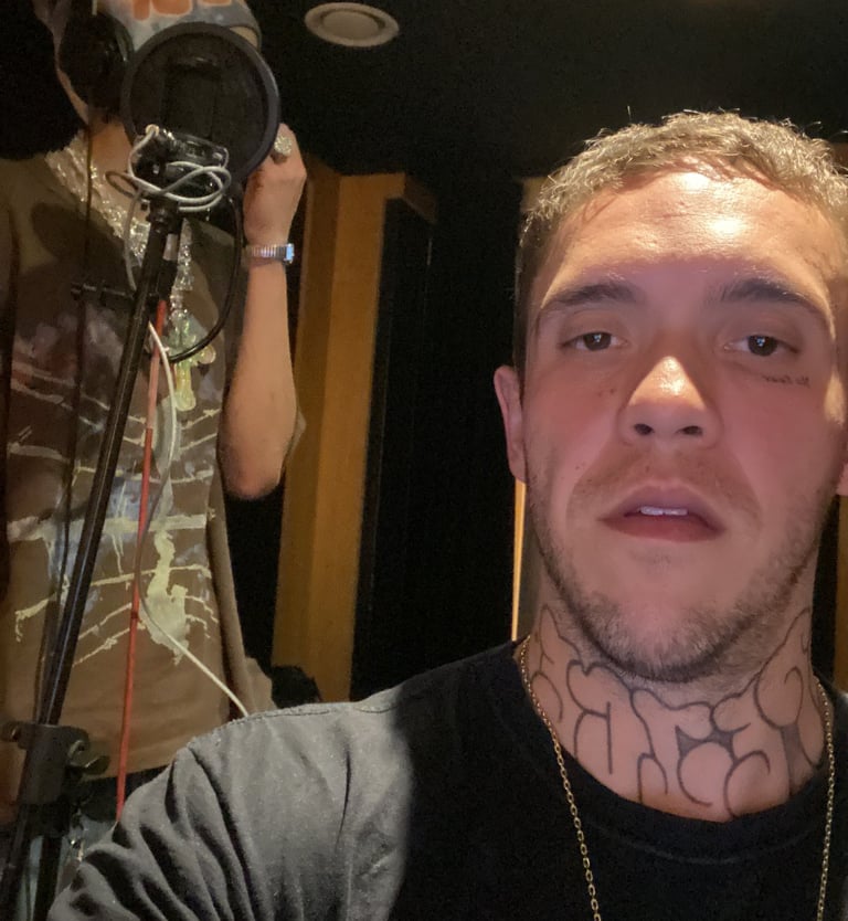a man with tattoos on his neck and neck