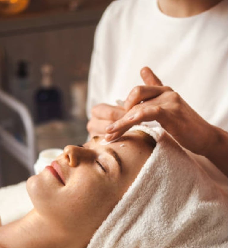 An image of a woman receiving a face massage