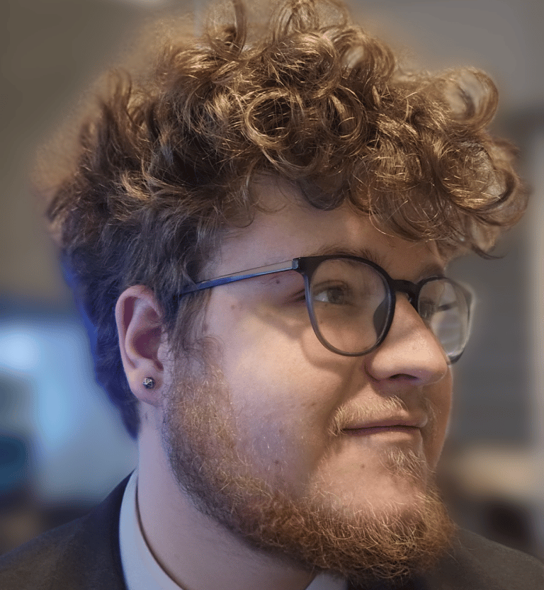 a man with a beard and glasses on his head