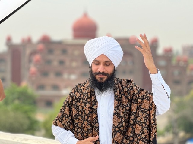 a man in a turban and a woman in a white shirt