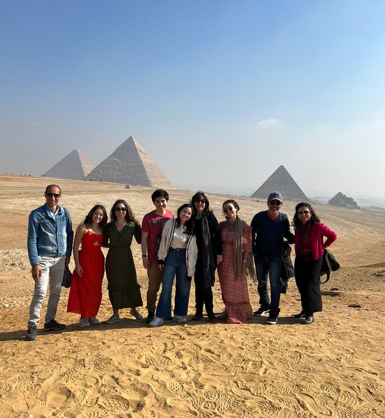 grupo de tuistas com foto panoramica e no fundo aparecem as misteriosas piramides de egito 