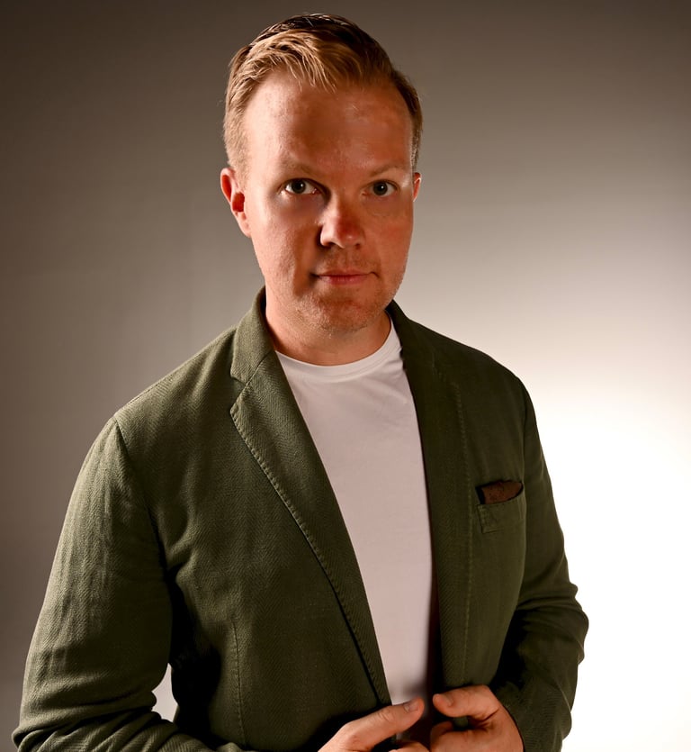 Nick Reese, AI, quantum, space expert in green blazer looking at camera