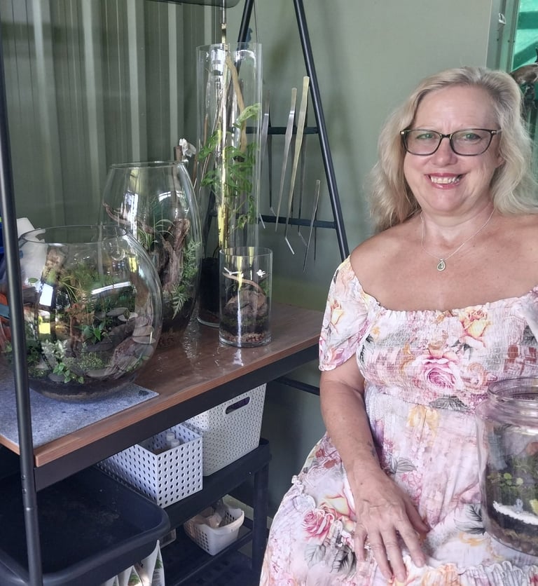 a woman in a floral dress sitting on a shelf