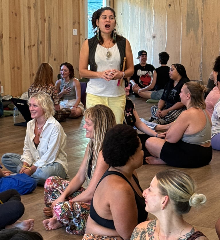 a woman in a white shirt is standing in a circle with other people