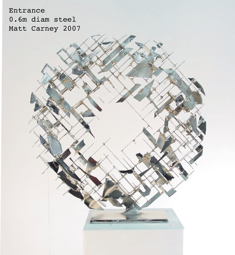 a silver cross-hatched circle sculpture