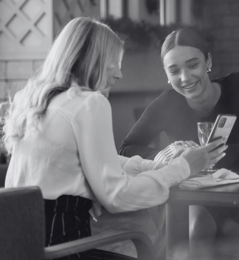 image of a mother and daughter at a restaurant with their piano piano selfie active