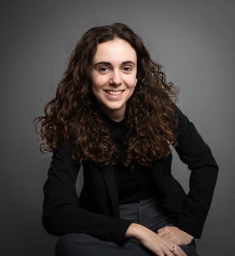 a woman with curly hair and a black jacket