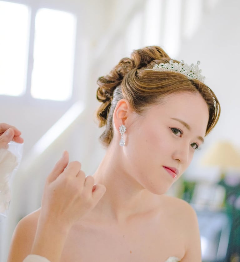 a woman in a wedding dress is wearing a tiablet