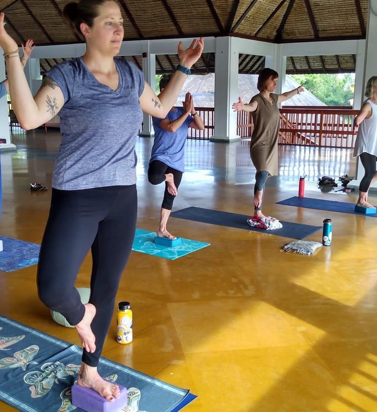 a woman in a yoga pose with a yoga mat