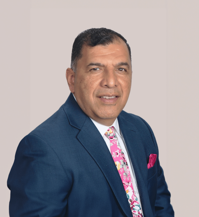 a man in a suit and tie with a pink tie