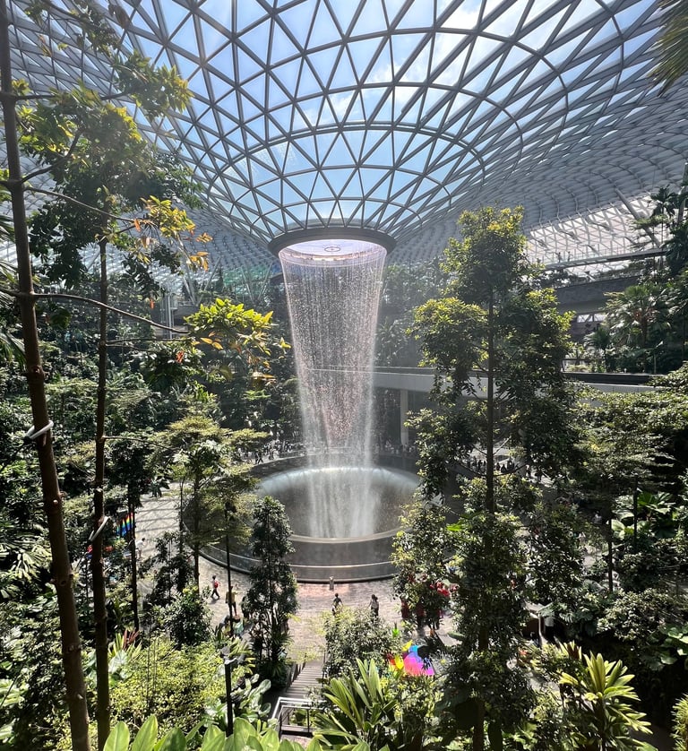 a waterfall in a large indoor dome Jewel Changi Airport