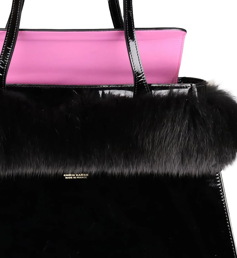 Luxury Chris Karch black patent leather tote bag with faux fur trim and pink lining.