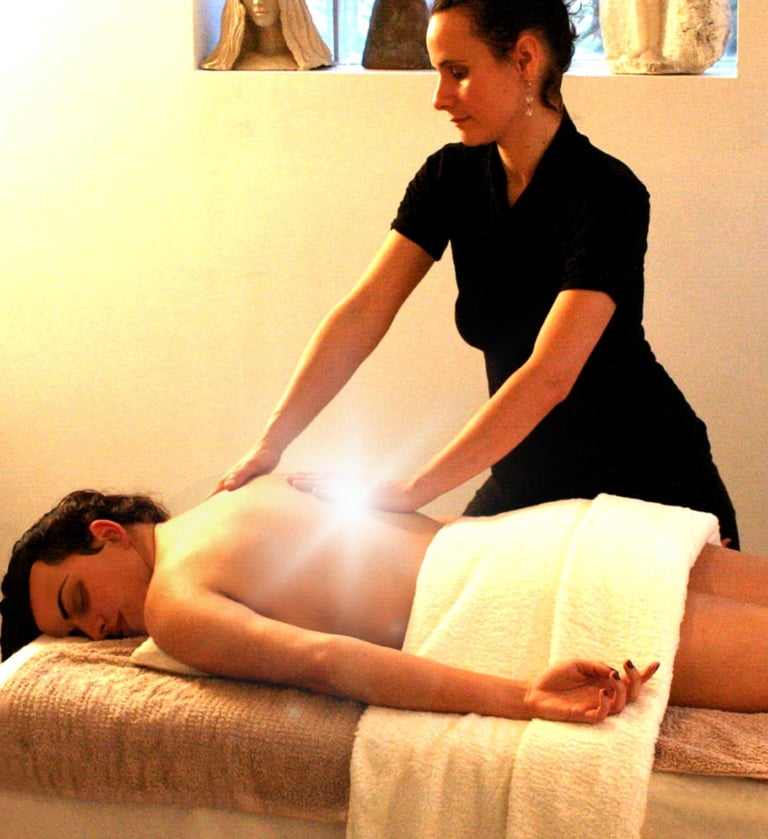 une praticienne de massage professionnelle fait un massage sur table, lumière blanche sous ses main 