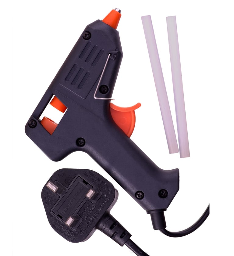 professional product photo of a hot glue gun showing the contents of the packet
