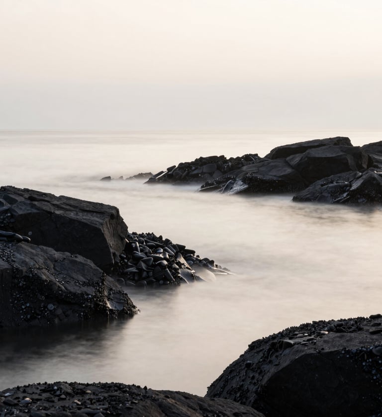 A minimalist, artistic landscape of the Brest shoreline in Brittany. The composition is clean, featuring dark charcoal rocks meeting a misty off-white sea. The lighting is soft and ethereal, reflecting a serene and sophisticated mood.