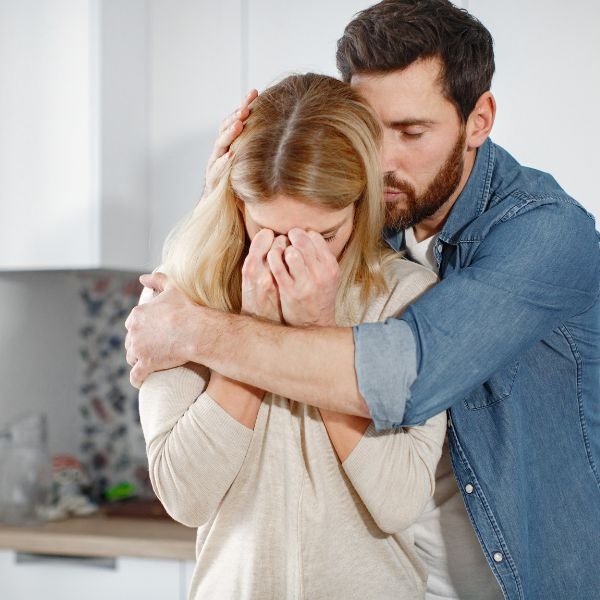 man consoling wife